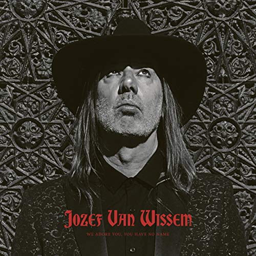 "Album cover featuring a man in a cowboy hat against an ornate metal background."