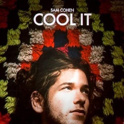 Album cover with a man in front of a colorful knitted background.