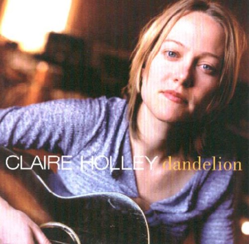 "CD cover featuring a woman holding a guitar, with artist name and album title."