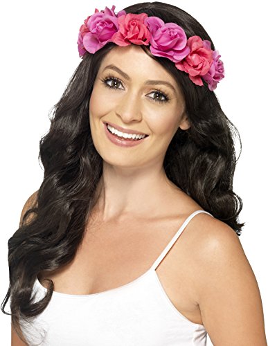 A woman wearing a pink floral headband and a white tank top smiles.