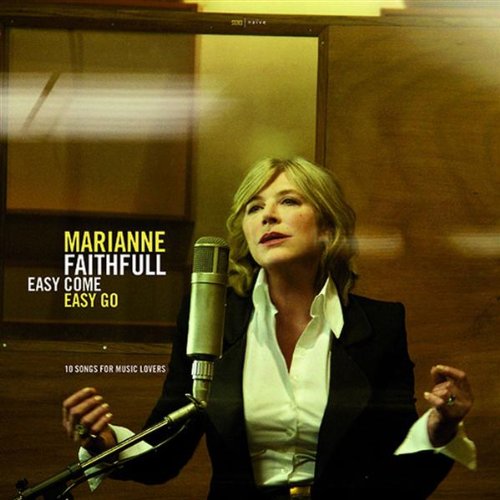 Marianne Faithfull sings into a microphone, wearing a white shirt and black blazer.