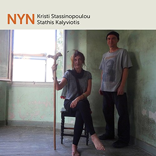 A man and woman in a room with peeling green walls and a window.