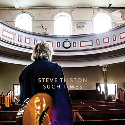"Album cover: man with guitar in a church, facing away from the camera."