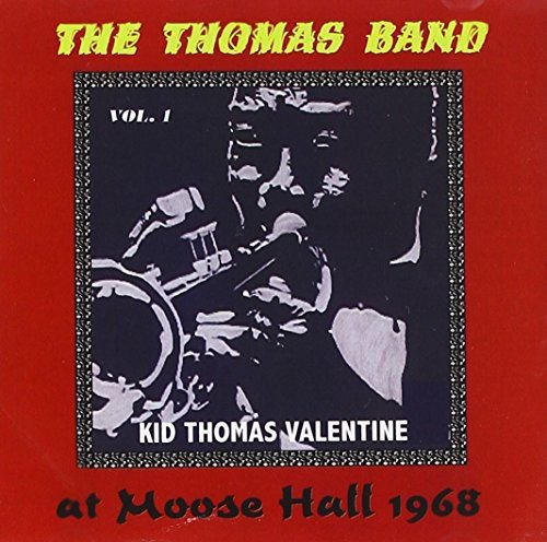 Red album cover with black and white image of a man playing a trumpet.
