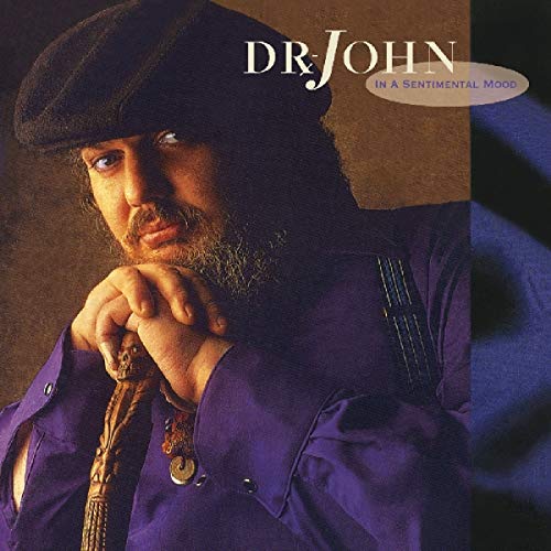 "CD cover featuring a man in a purple shirt and black beret."