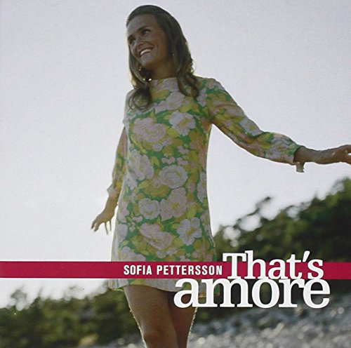 "Album cover featuring a smiling woman in a floral dress outdoors."