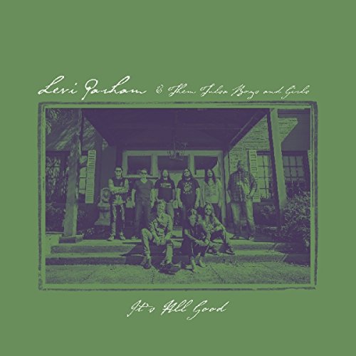 "Green vinyl album cover with a purple-toned group photo and cursive text."