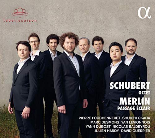 "CD cover featuring eight men in black suits standing together outdoors."