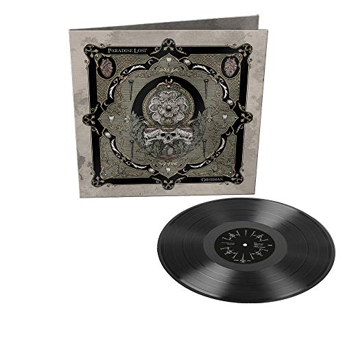 "Black vinyl record with album cover featuring ornate grey and black design."