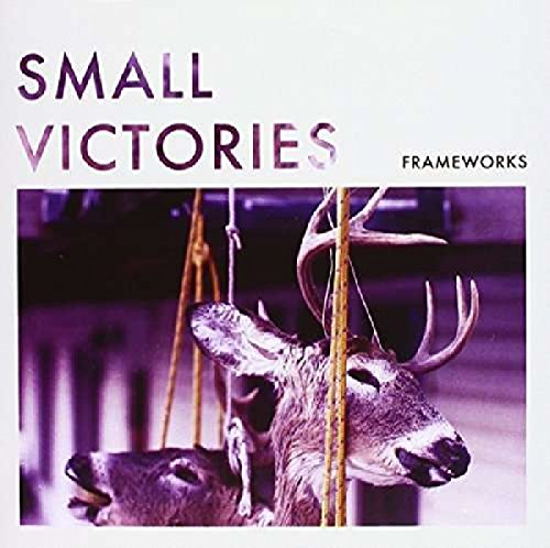 The image depicts a vinyl record cover featuring a deer suspended from ropes. Alt text: "Vinyl record cover with deer hanging from ropes, purple-toned image."