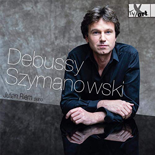 CD cover with a man in a dark shirt against a gray background.