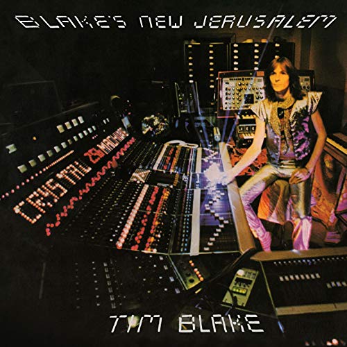 The album cover for "Blake's Jerusalem" by Tim Blake features a man surrounded by sound equipment, sitting in a dimly lit room. The image is described as: A man with long hair, wearing a white shirt and black vest, sits amidst a complex array of soundboards and synthesizers, with the title "Blake's Jerusalem" and artist name "Tim Blake" displayed prominently. Alt text: Man surrounded by sound equipment in a dark room.