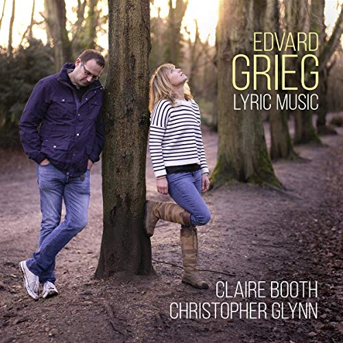 "CD cover featuring a man and woman leaning against a tree in a forest."