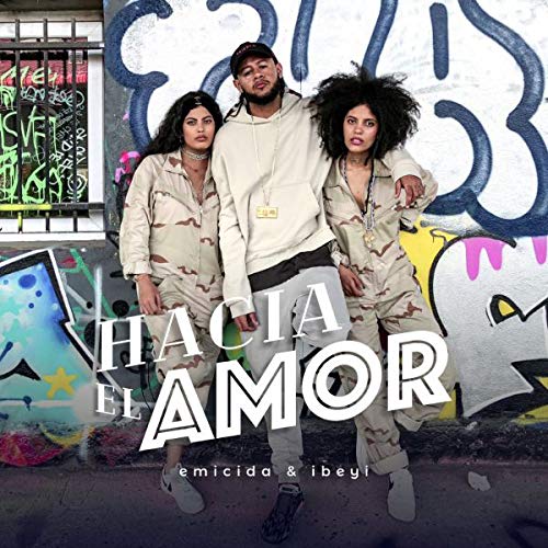 Vinyl album cover with three people standing in front of graffiti.