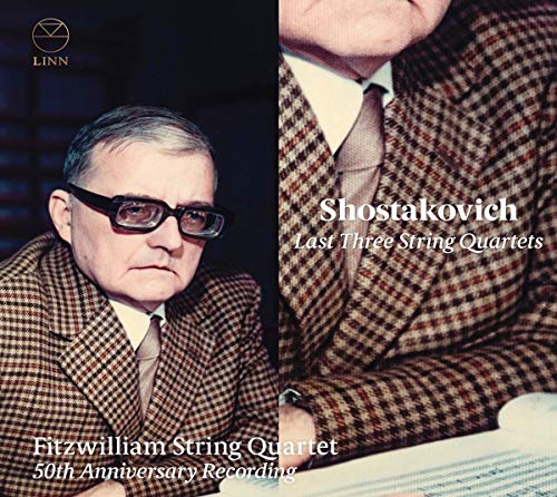A man in a plaid suit is shown on a CD cover.