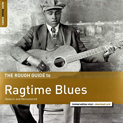 "Black and white album cover with man playing guitar, gold and brown accents."