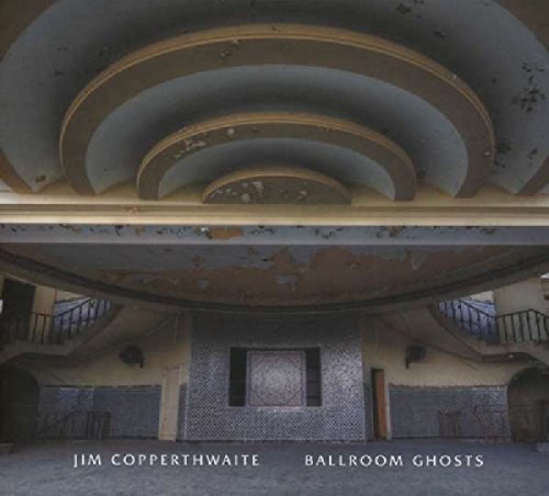 "Album cover featuring a rundown, circular ballroom with peeling paint and tiled walls."