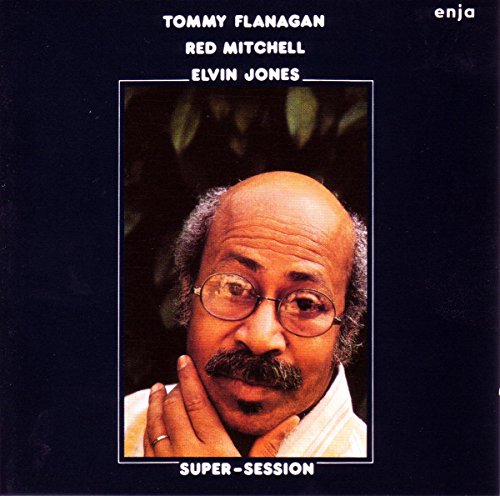"CD cover featuring a man with a mustache and glasses on a black background."