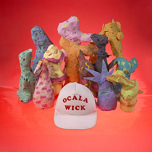 White baseball cap with "Ocala Wick" in red, surrounded by colorful abstract clay figures.
