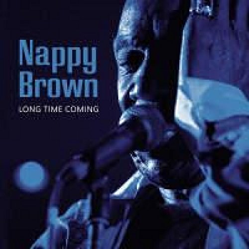 "Album cover featuring a close-up of a man singing into a microphone."
