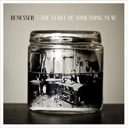 "Album cover with a black-and-white image of people in a jar."