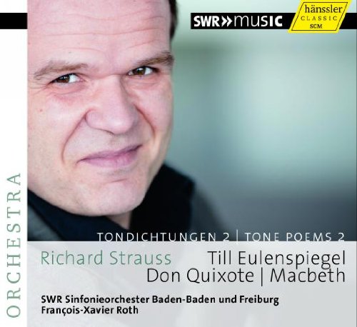 "CD cover featuring a man's face, with text and logos on a grey background."