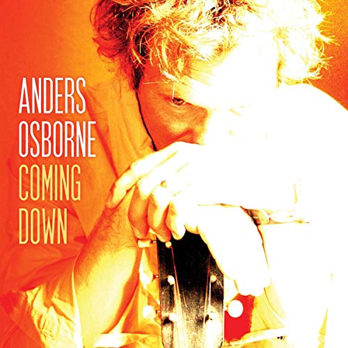 Album cover with a man holding a guitar, orange and yellow tones.