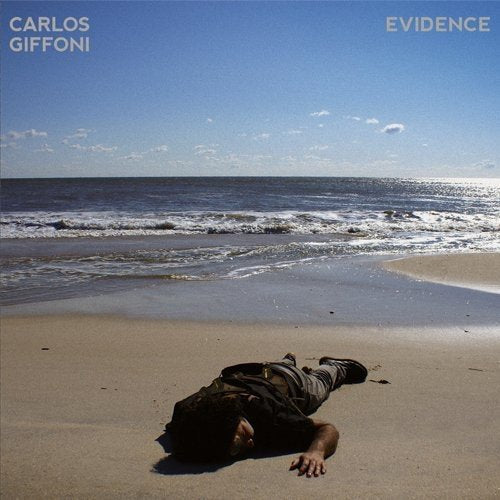 Vinyl album cover with a man lying on a beach, wearing a backpack.