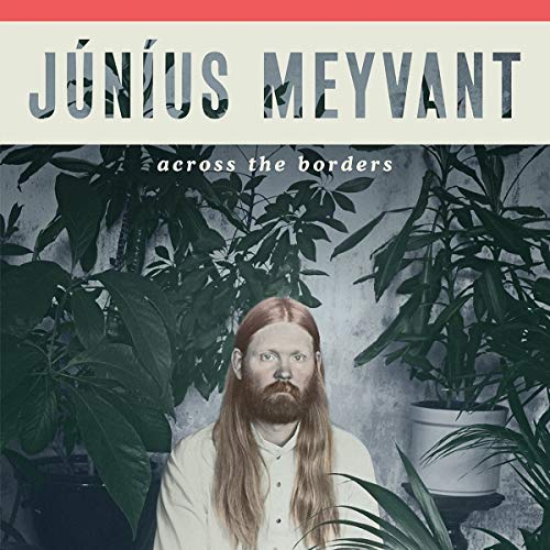 "Vinyl album cover featuring a man with long hair surrounded by plants."