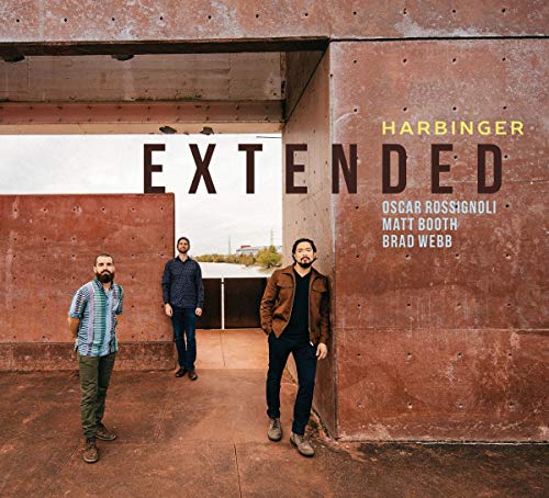 Album cover: three men standing in a concrete passageway, with "EXTENDED - HARBINGER" text.