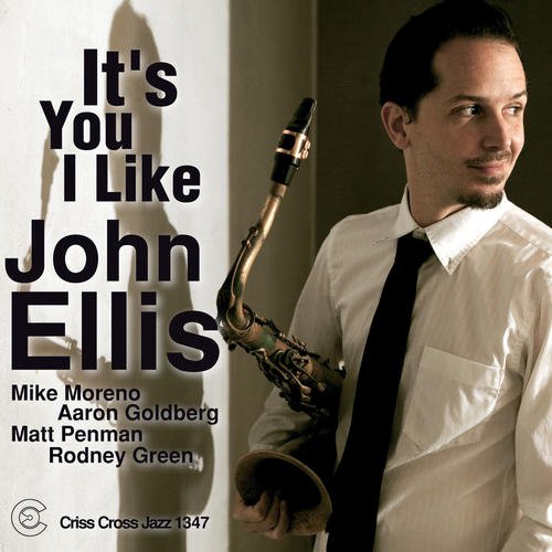 Album cover with a man holding a saxophone, wearing a white shirt and black tie.