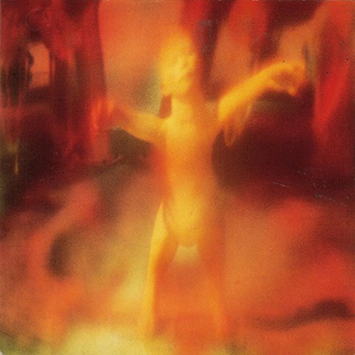 "Album cover with abstract orange and yellow image on black background, titled 'Monumentum'."