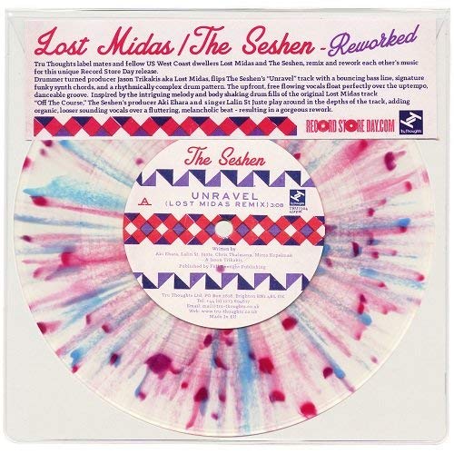 A vinyl record with a white label and multi-colored splatter design.