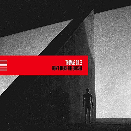 "Album cover with a person in a dark room, red banner with artist and title."