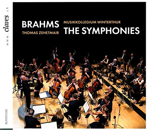 A CD cover featuring an orchestra performing on stage with a conductor.