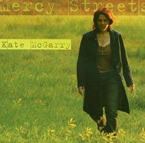 Album cover of "Mercy Streets" by Kate McGarry, featuring a woman in a field.