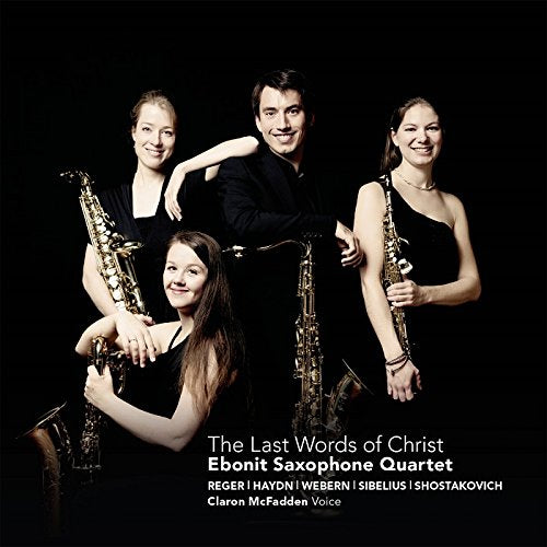 CD cover featuring the Ebonit Saxophone Quartet in black, holding saxophones against a black background.