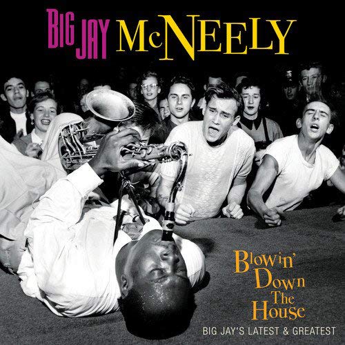 "Vinyl record cover with black-and-white image and vinyl partially visible."
