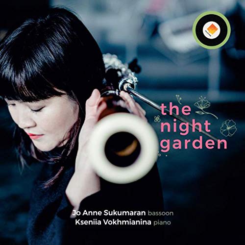 Woman holding a bassoon, with "the night garden" text on a dark background.