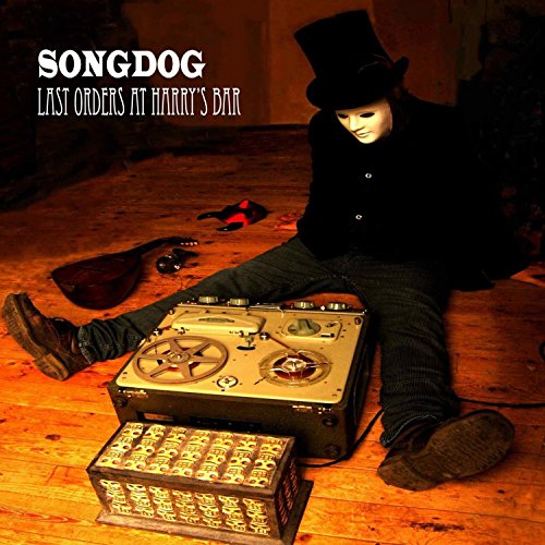 "Album cover: man in top hat sitting with old recording equipment on wooden floor."