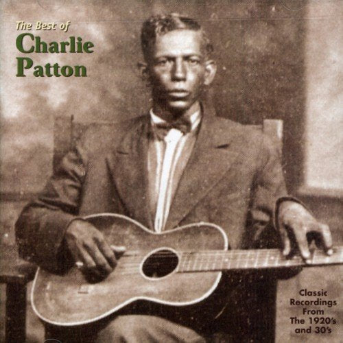 Black-and-white album cover featuring Charlie Patton holding a guitar, with green text overlay.