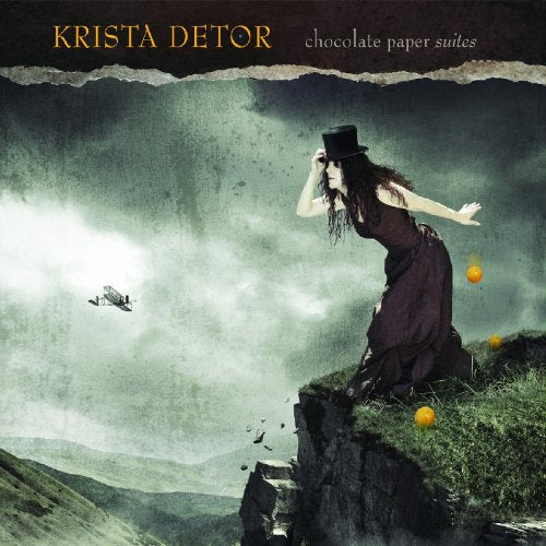 "CD cover featuring a woman in a dress on a cliff."
