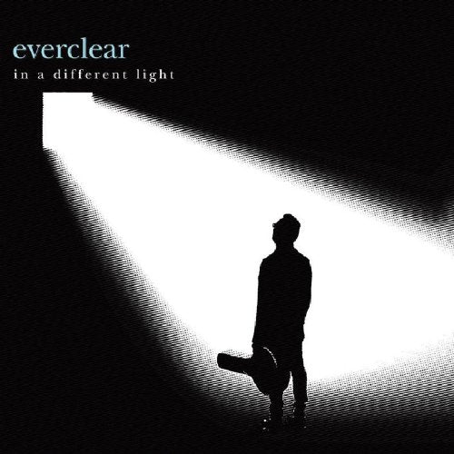 "Album cover featuring a silhouette of a man holding a guitar case in a spotlight."