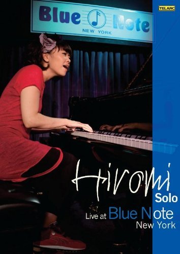 Woman in red dress plays piano under Blue Note New York sign on DVD cover.