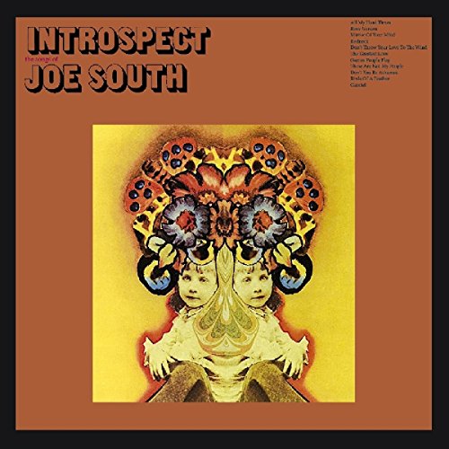 The alt text for the image is: "Orange album cover with a mirrored face design."