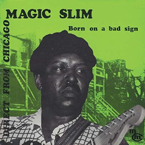 "Vinyl album cover featuring a man holding a guitar, with green-toned background image."