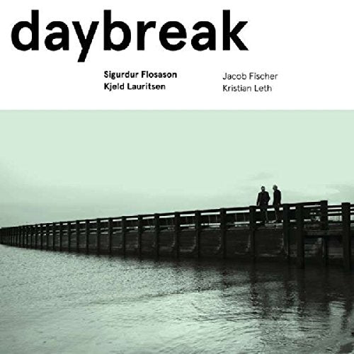 "CD cover with two silhouetted figures on a long pier, pale greenish-gray background."