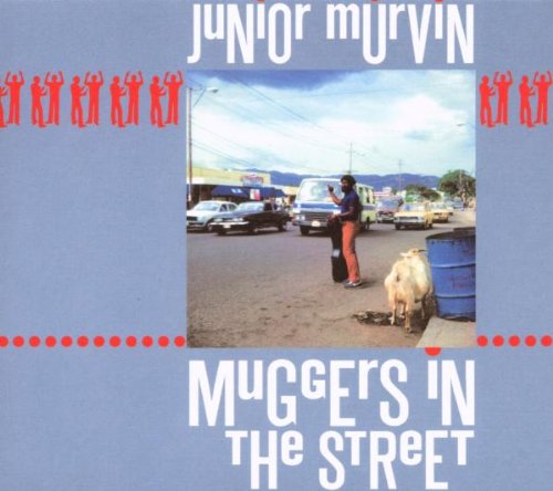 Album cover with a man and goat on a dusty street.
