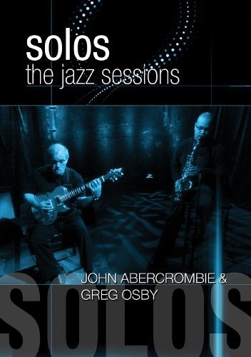 DVD cover featuring two musicians, one with guitar, one with saxophone, in dark setting.