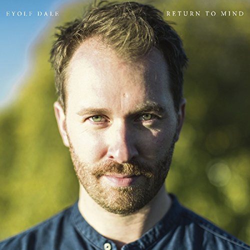 "Album cover featuring a man with short brown hair and beard, outdoors."